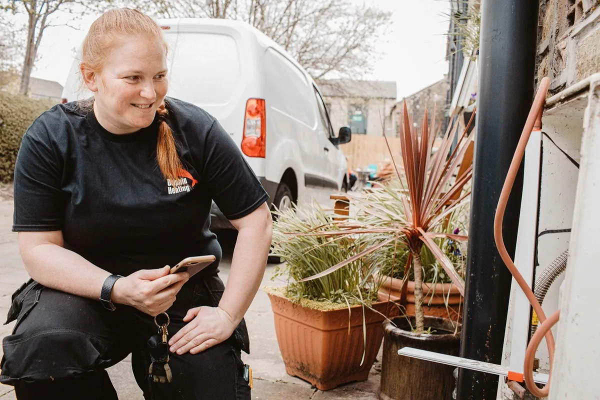 Fay from Dolphin Heating beside her van on a job in Huddersfield